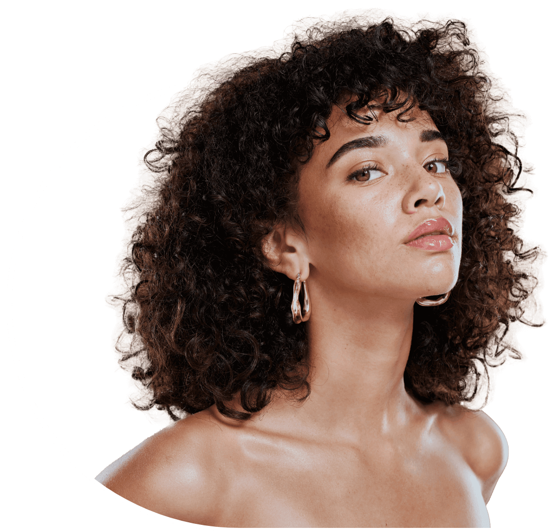 Photo of a woman with curly hair wearing golden hoop earings
