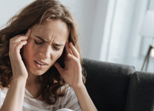 Photo of a woman with a migraine