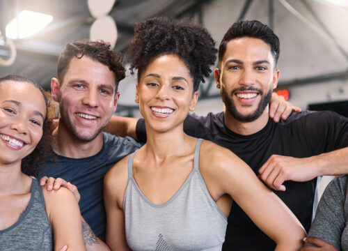 Photo of a group of smiling people at the gym